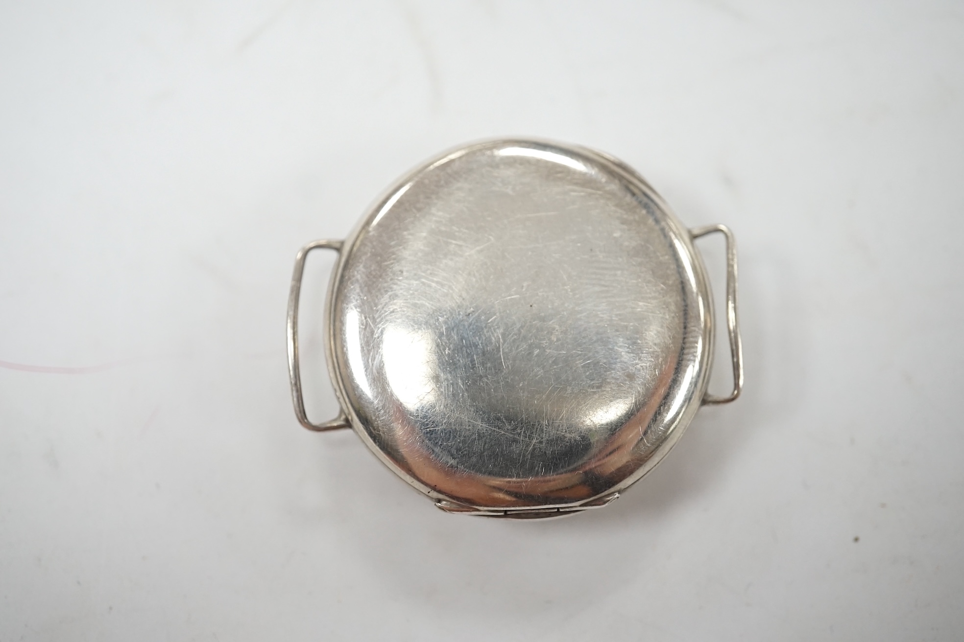 A George V silver manual wind trench watch with 'telephone dial' shrapnel guard, case import marked for London, 1917, case diameter 35mm, lacking winding crown. No strap. Condition - poor